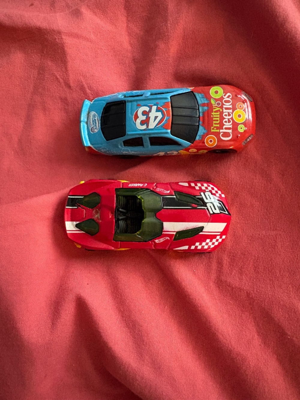 Matchbox cars. One is a NASCAR